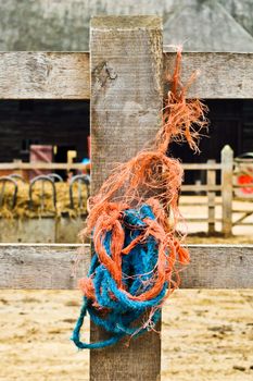 Cloe up of rope on a fence post at a farm yard