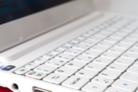 White laptop keyboard close-up. Mini laptop.