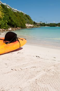 available orange kayak on a white sandy beach, Long Bay in Antigua