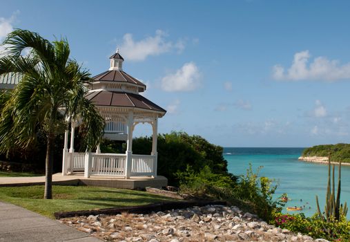 white gazebo with view to a tropical beach on Long Bay, Antigua (blue sky)