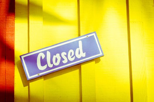 Colrful closed sign on a doorway in a tropical place