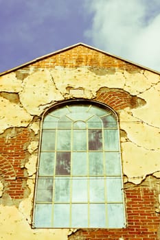 An old industrial building window with decaying walls