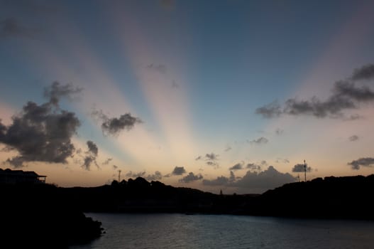 gorgeous rays of light, sunset view with land and seascape of Long Bay in Antigua (intentional silhouette picture)