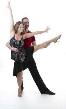 couple dancing salsa in the middle of a pose