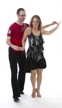 couple dancing salsa in the middle of a pose