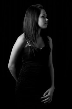 Black and white portrait of a young woman in a little black dress