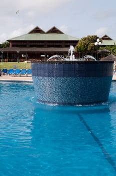 gorgeous swimming pool with fountain on a tropical resort (caribbean vacations)