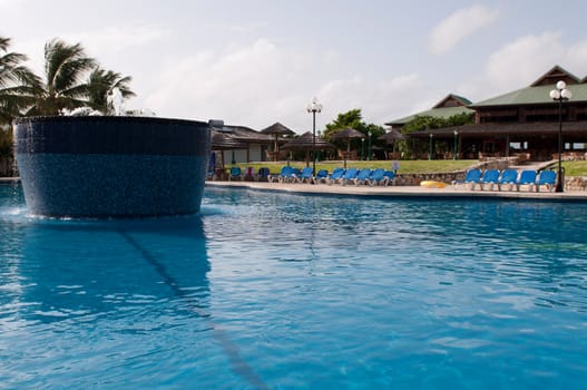 gorgeous swimming pool with fountain on a tropical resort (caribbean vacations)