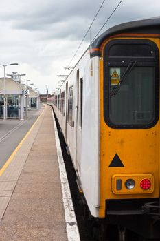 A long commuter train parked at Cambridge railway station, UK