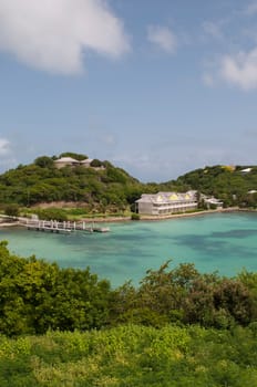 Antigua Long Bay, gorgeous seascape view surrounded by tropical nature and some typical houses