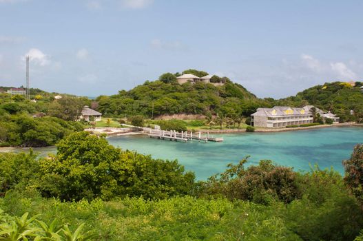 Antigua Long Bay, gorgeous seascape view surrounded by tropical nature and some typical houses