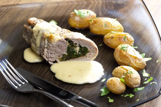 baked pork tenderloin filled with spinach and goat cheese on cream