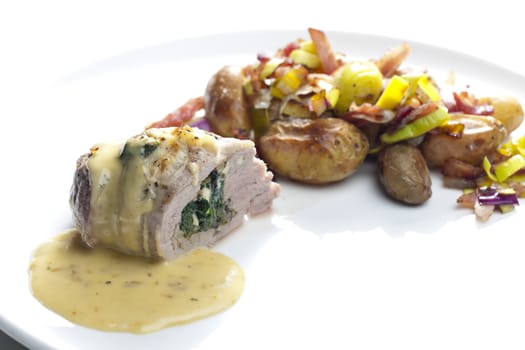 baked pork tenderloin filled with spinach and goat cheese on cream