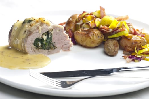 baked pork tenderloin filled with spinach and goat cheese on cream