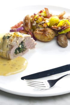 baked pork tenderloin filled with spinach and goat cheese on cream