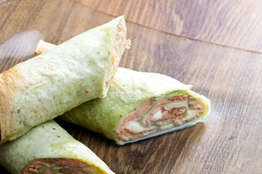 spinach tortilla filled with salmon and mozzarella