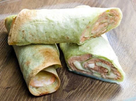 spinach tortilla filled with salmon and mozzarella