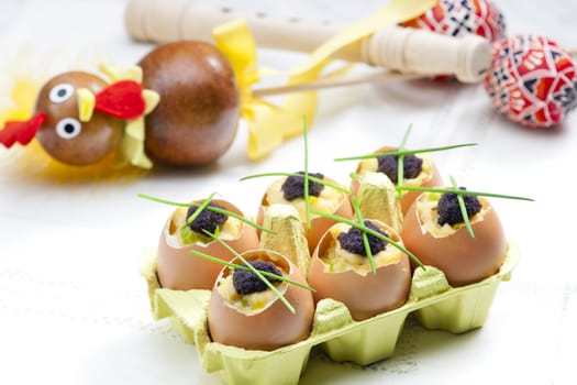 Easter still life with scrambled eggs, chives and black caviar
