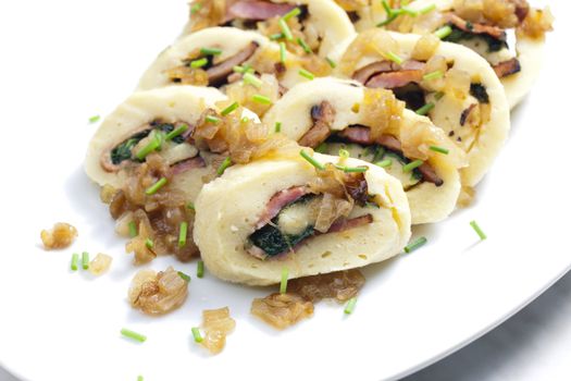 roll from potato dough filled with spinach and bacon