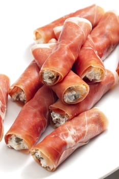 Parma ham rolls filled with cream cheese, Galia melon and capers