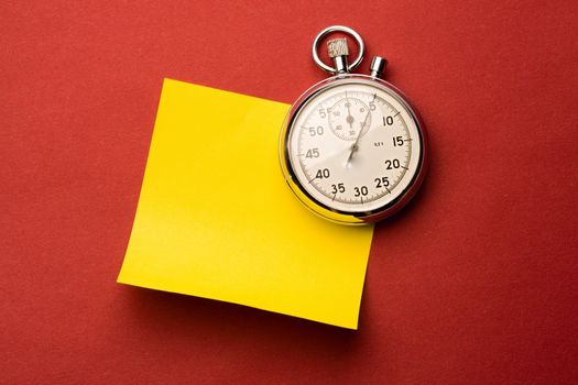 Stopwatch and label isolated on red