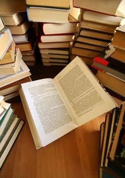 Many old books combined by a heap. Russian saying 'Knowledge - light, ignorance - darkness'