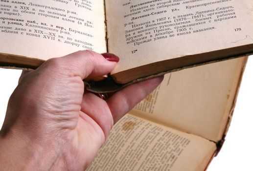 Woman's hands hold the old book