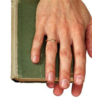 Man's hands hold the old green book