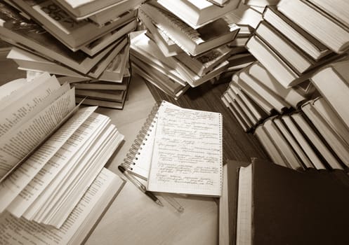 Many old books combined by a heap. Russian saying 'Knowledge - light, ignorance - darkness'