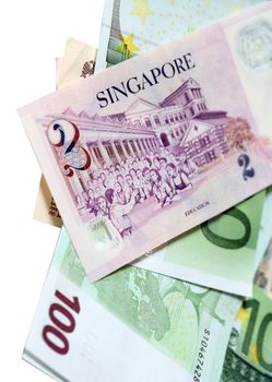 Two singapore dollars and banknotes euro