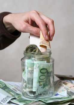 Bank with money and man's hand