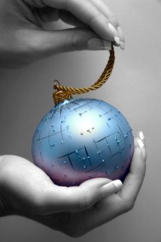 Blue sphere in female hands. Partial decolouration