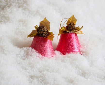 Two pink handbells in snow