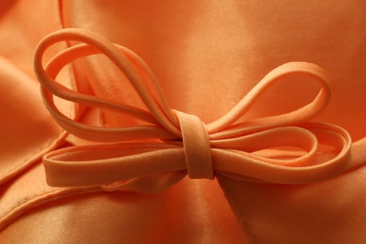 Silk textile background with a bow