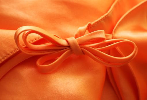 Silk textile background with a bow