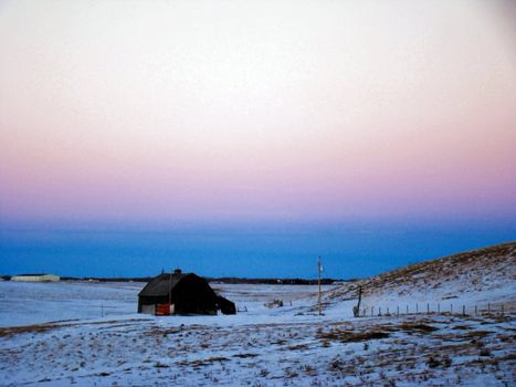 old barn on the Canadian praries with beautiful sunset sky