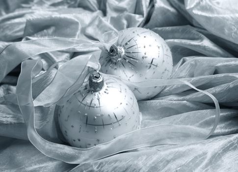 Two christmas spheres on a fabric with a tape