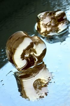 The image of glass heart with reflection in a smooth surface
