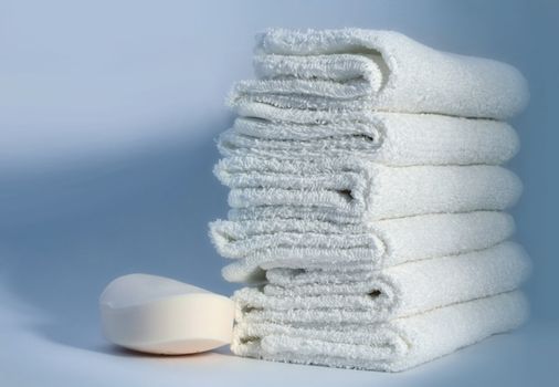 White towels and soap on a blue background