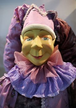 Portrait of the doll - clown in a pink cap