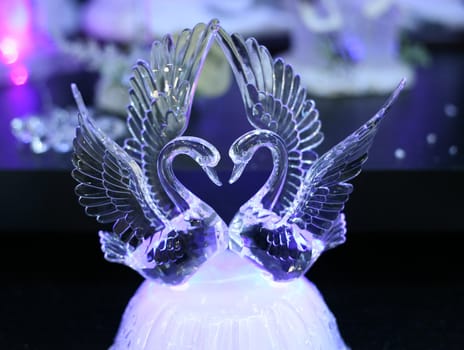 Crystal swans on a dark background