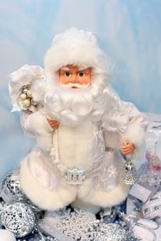 Toy Santa Claus with gifts and a bell