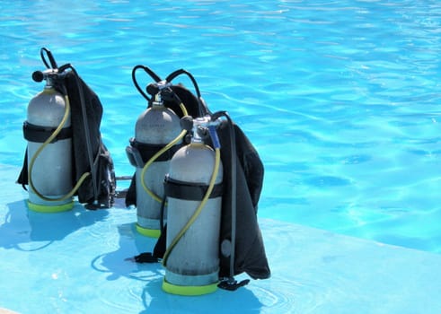 three oxygen tanks ready for scuba diving