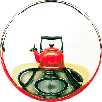 A traditional red whistling kettle on a gas hob