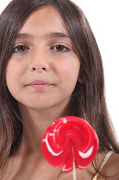 little girl licking a lollipop