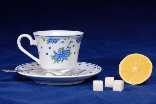 Cup of tea with lemon and sugar cube