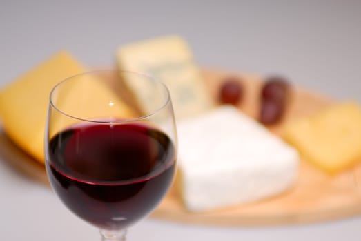 Glass of red wine and cheese plate