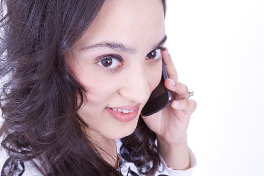 Mexican lady on the cell phone, looking up at camera, shot from above.