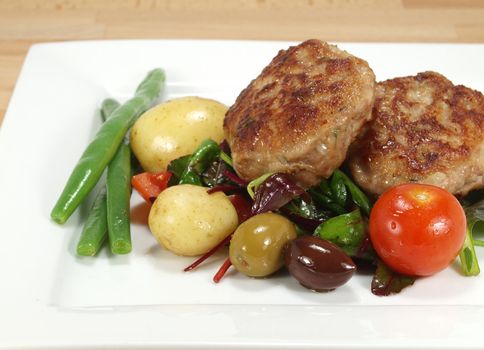 pan-fried danish dumplings or frikadeller with salads and vegetables