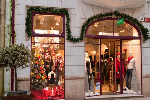 TOMAR, PORTUGAL - DECEMBER 15: Benetton Boutique entrance and window with dressed mannequins (Christmas decorations) in Tomar, Portugal on December 15, 2011 in Tomar, Portugal